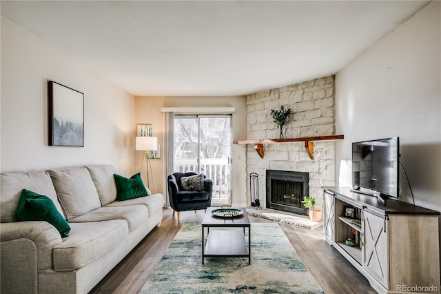 living room with dark wood-type flooring and a fireplace