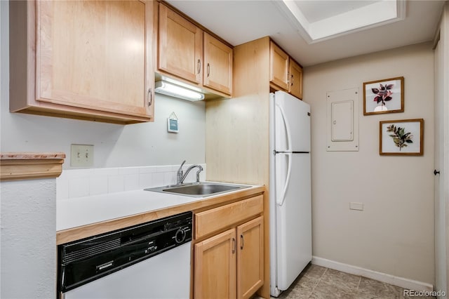 kitchen with white appliances, light brown cabinets, light countertops, and a sink