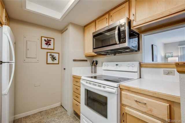 kitchen featuring light countertops, white appliances, light brown cabinetry, and baseboards