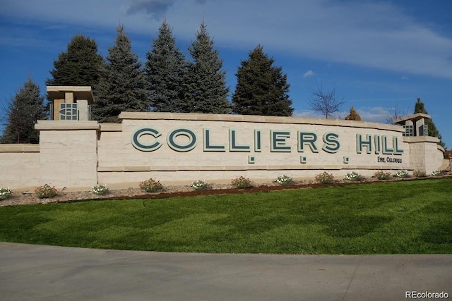 community / neighborhood sign with a lawn