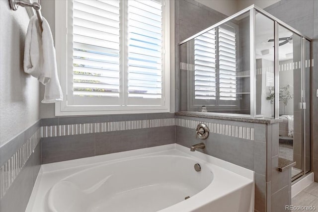 bathroom featuring shower with separate bathtub and plenty of natural light