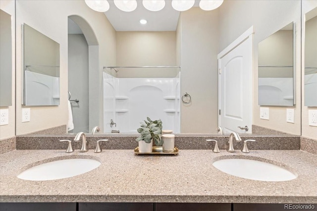 bathroom featuring vanity and a shower