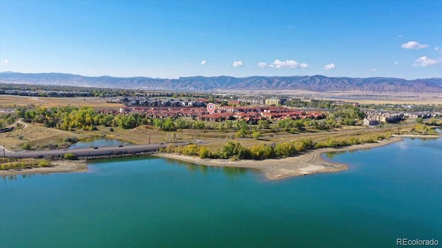 drone / aerial view featuring a water and mountain view