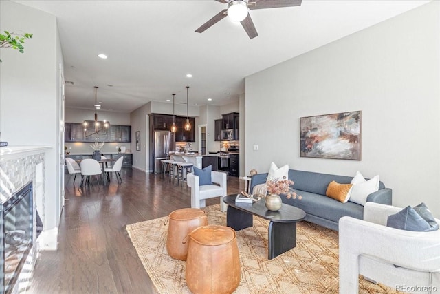 living room with a fireplace, beverage cooler, dark hardwood / wood-style flooring, and ceiling fan