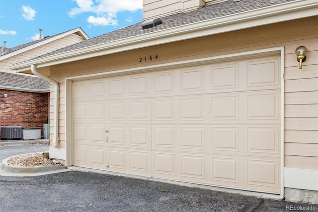 2164 S Troy Way, Aurora, CO 80014 - garage with cooling unit and driveway