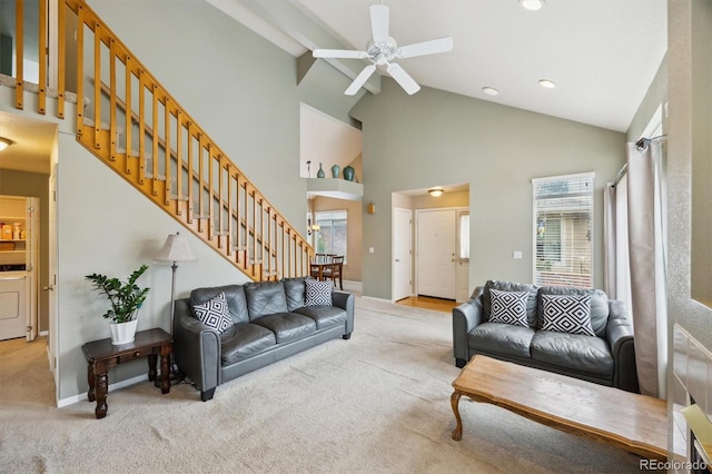 2164 S Troy Way, Aurora, CO 80014 - carpeted living room featuring washer / dryer, healthy amount of natural light, a ceiling fan, stairway, and high vaulted ceiling