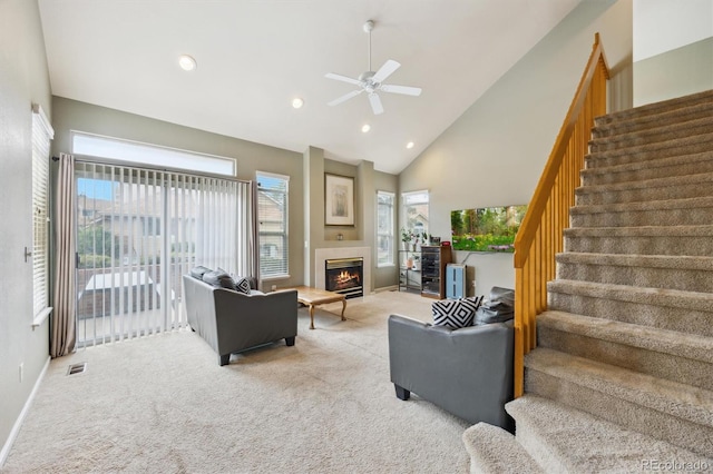 2164 S Troy Way, Aurora, CO 80014 - carpeted living room featuring stairway, ceiling fan, a glass covered fireplace, high vaulted ceiling, and recessed lighting