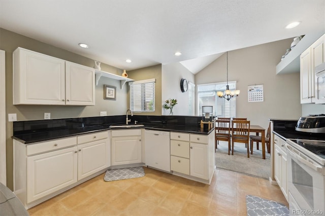 2164 S Troy Way, Aurora, CO 80014 - kitchen featuring white appliances, a sink, vaulted ceiling, a chandelier, and white cabinetry