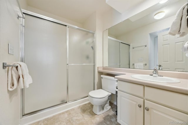 2164 S Troy Way, Aurora, CO 80014 - bathroom with vanity, a stall shower, and toilet