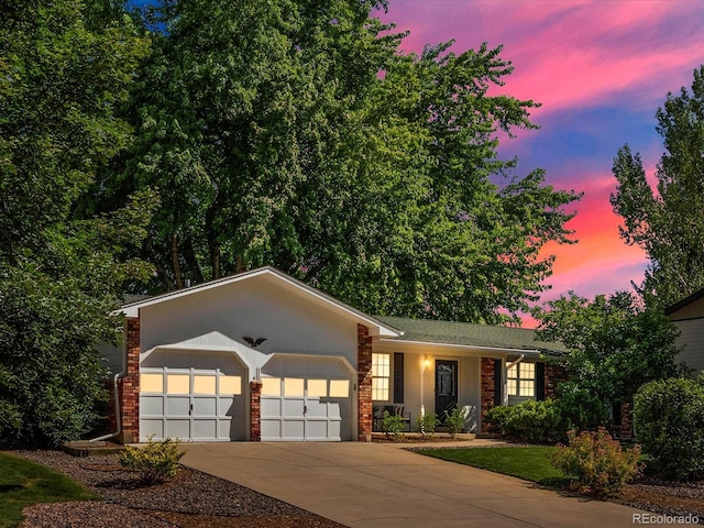 1067 E 15th Ave, Broomfield, CO 80020 - single story home featuring driveway, an attached garage, brick siding, and stucco siding