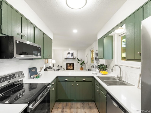 1067 E 15th Ave, Broomfield, CO 80020 - kitchen with stainless steel appliances, green cabinetry, and light countertops