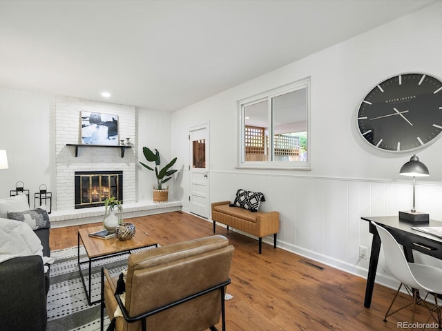 1067 E 15th Ave, Broomfield, CO 80020 - living room with wood finished floors and a brick fireplace