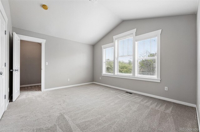 9134 E 29th Pl, Denver, CO 80238 - unfurnished room featuring lofted ceiling, carpet flooring, baseboards, and a smoke detector