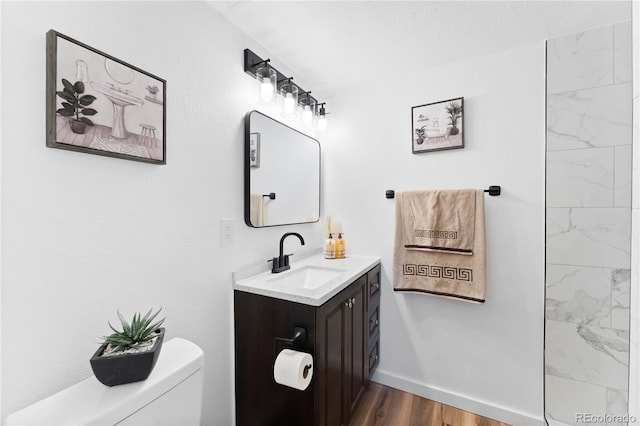 bathroom featuring hardwood / wood-style flooring, vanity, and toilet