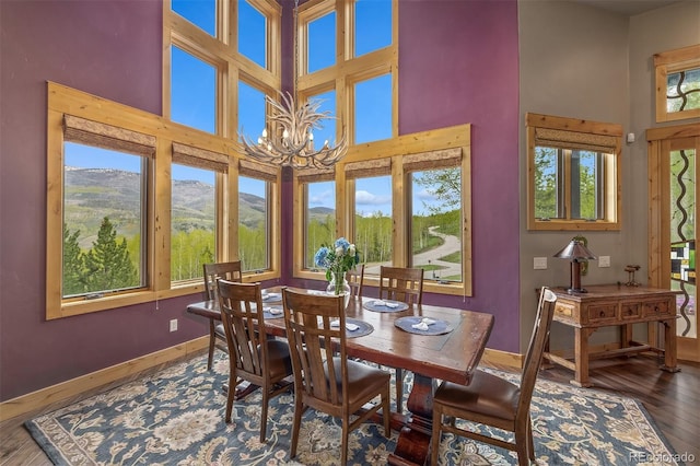 2655 Hunters Knob Rd, Silverthorne, CO 80498 - dining room featuring a high ceiling, wood-type flooring, a mountain view, and a chandelier