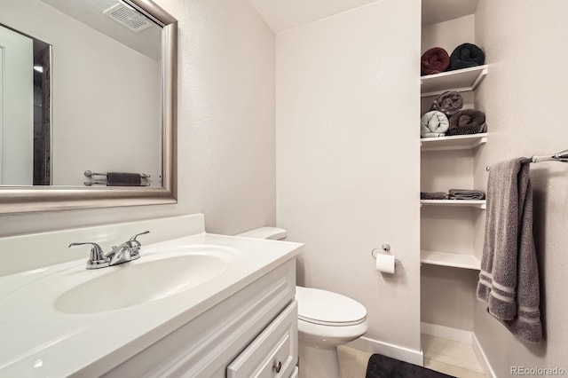 202 Ash St, Bennett, CO 80102 - bathroom featuring vanity, toilet, and baseboards