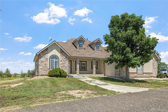 34771 E 153rd Ct, Hudson, CO 80642 - view of front of property with stone siding, stucco siding, a front yard, and a porch