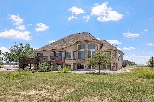 34771 E 153rd Ct, Hudson, CO 80642 - back of property featuring a wooden deck, a lawn, stucco siding, and stone siding