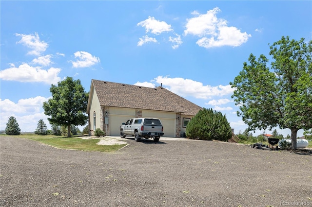 34771 E 153rd Ct, Hudson, CO 80642 - view of property exterior featuring an attached garage and driveway
