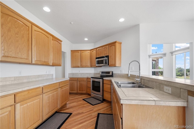 34771 E 153rd Ct, Hudson, CO 80642 - kitchen with stainless steel appliances, light wood-style floors, recessed lighting, and a peninsula