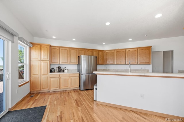 34771 E 153rd Ct, Hudson, CO 80642 - kitchen with freestanding refrigerator, light countertops, light wood-style flooring, and recessed lighting