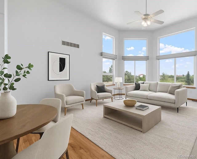 34771 E 153rd Ct, Hudson, CO 80642 - living room with healthy amount of natural light, ceiling fan, light wood-style floors, and a high ceiling