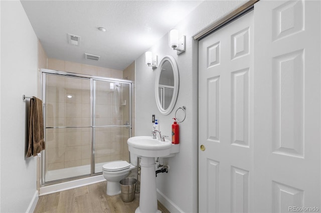34771 E 153rd Ct, Hudson, CO 80642 - bathroom featuring wood finished floors and a stall shower