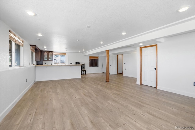 34771 E 153rd Ct, Hudson, CO 80642 - unfurnished living room featuring recessed lighting, light wood-type flooring, and a textured ceiling