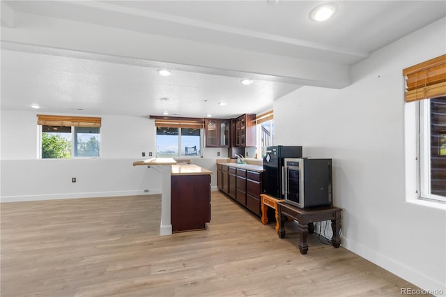34771 E 153rd Ct, Hudson, CO 80642 - kitchen featuring light countertops, glass insert cabinets, healthy amount of natural light, light wood-type flooring, and recessed lighting
