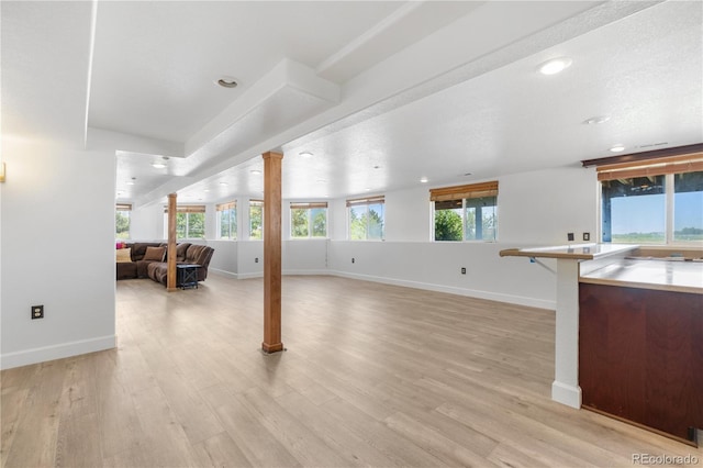 34771 E 153rd Ct, Hudson, CO 80642 - unfurnished living room featuring ornate columns, light wood-style flooring, and recessed lighting