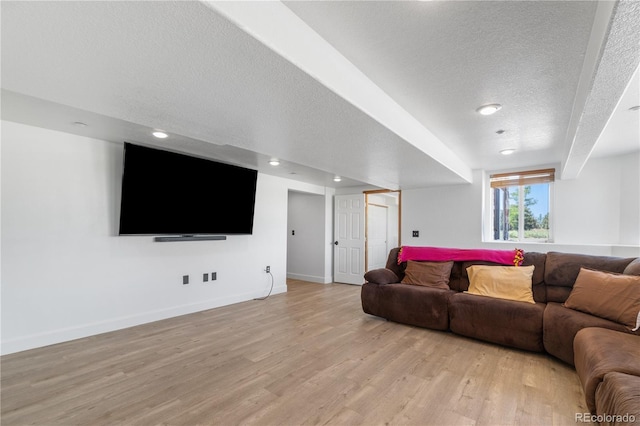 34771 E 153rd Ct, Hudson, CO 80642 - living room with light wood-type flooring, a textured ceiling, and recessed lighting