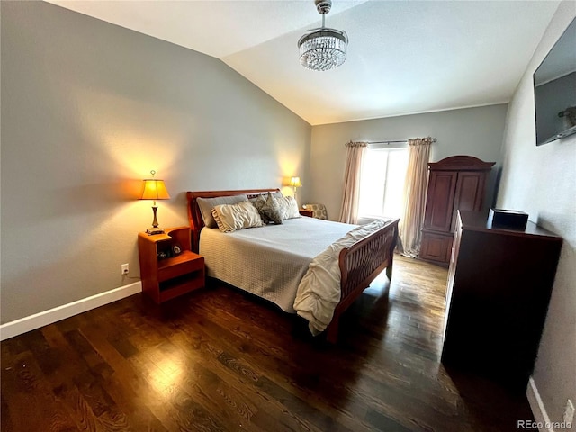 bedroom with lofted ceiling and dark hardwood / wood-style floors