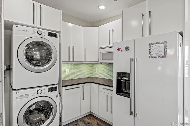 825 Hill Road Ct, Colorado Springs, CO 80909 - washroom featuring stacked washer / dryer, dark wood-style floors, and recessed lighting