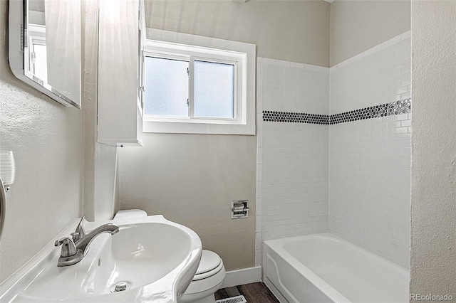 825 Hill Road Ct, Colorado Springs, CO 80909 - bathroom featuring a sink, toilet, baseboards, and bathtub / shower combination