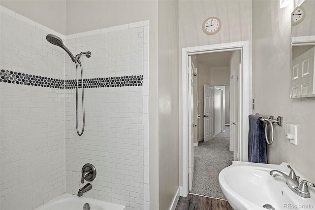 825 Hill Road Ct, Colorado Springs, CO 80909 - bathroom featuring a sink, shower / bath combination, wood finished floors, and baseboards