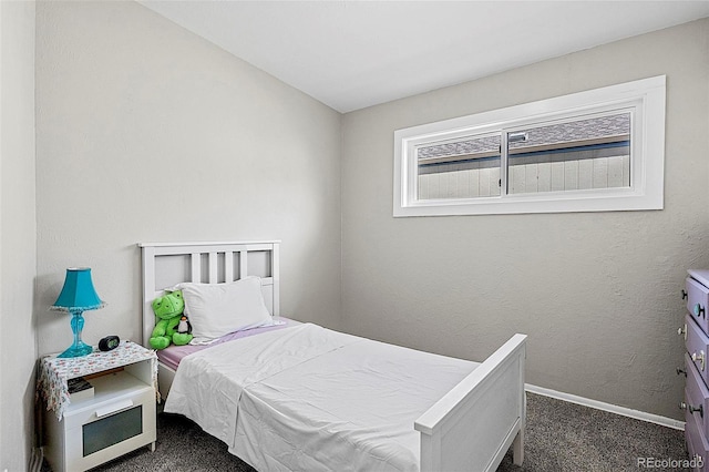 825 Hill Road Ct, Colorado Springs, CO 80909 - bedroom with dark colored carpet and baseboards