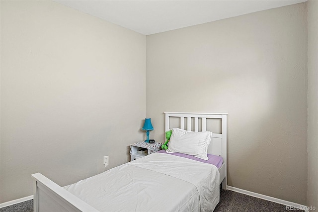 825 Hill Road Ct, Colorado Springs, CO 80909 - bedroom featuring baseboards and dark colored carpet
