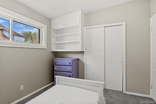 825 Hill Road Ct, Colorado Springs, CO 80909 - bedroom with carpet, a closet, baseboards, and a textured wall