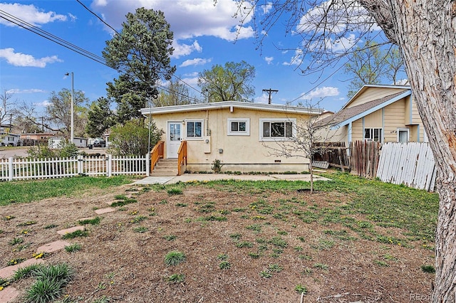 825 Hill Road Ct, Colorado Springs, CO 80909 - back of house with a fenced backyard and stucco siding