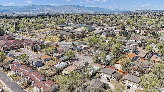 825 Hill Road Ct, Colorado Springs, CO 80909 - aerial view of property and surrounding area with mountains and nearby suburban area