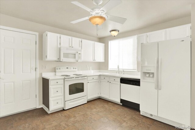 kitchen with white appliances, ceiling fan, white cabinetry, and sink