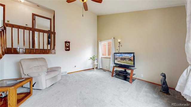 sitting room with ceiling fan, carpet floors, and baseboards