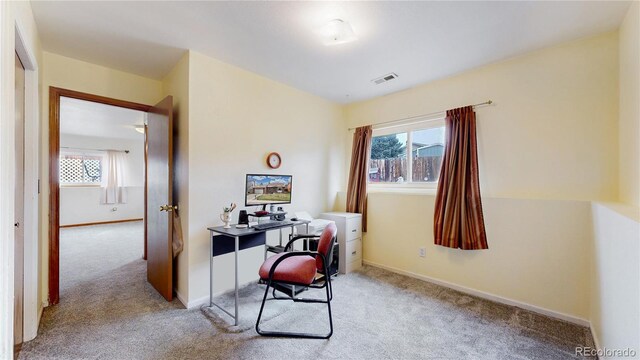 home office with carpet floors, plenty of natural light, and baseboards