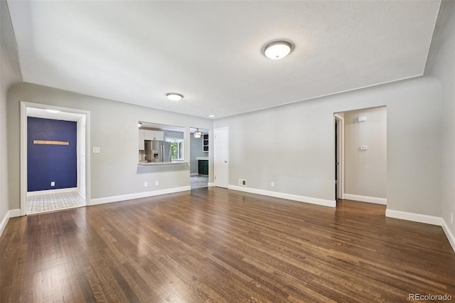 4560 S Fox St, Englewood, CO 80110 - unfurnished living room featuring dark wood finished floors and a ceiling fan