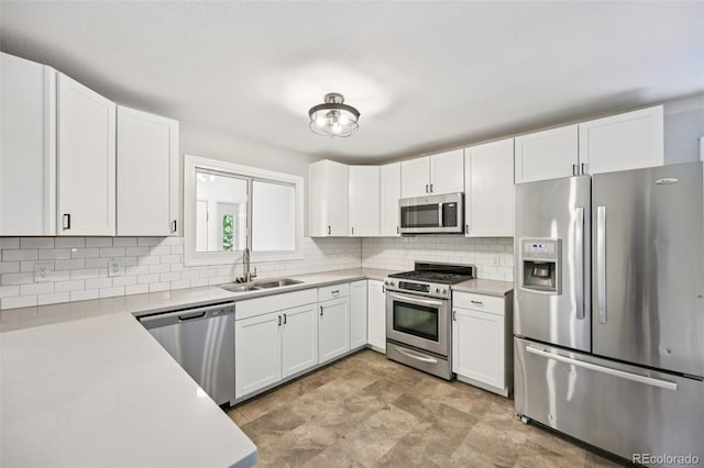 4560 S Fox St, Englewood, CO 80110 - kitchen with stainless steel appliances, light countertops, tasteful backsplash, and white cabinetry