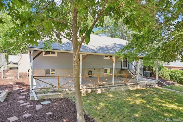 4560 S Fox St, Englewood, CO 80110 - back of property featuring a patio, a lawn, and roof with shingles