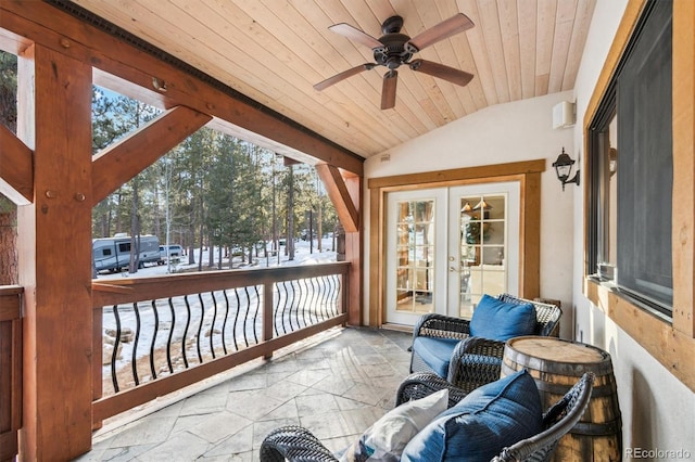 sunroom / solarium featuring lofted ceiling, a wealth of natural light, wood ceiling, and french doors