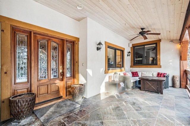 doorway to property with ceiling fan