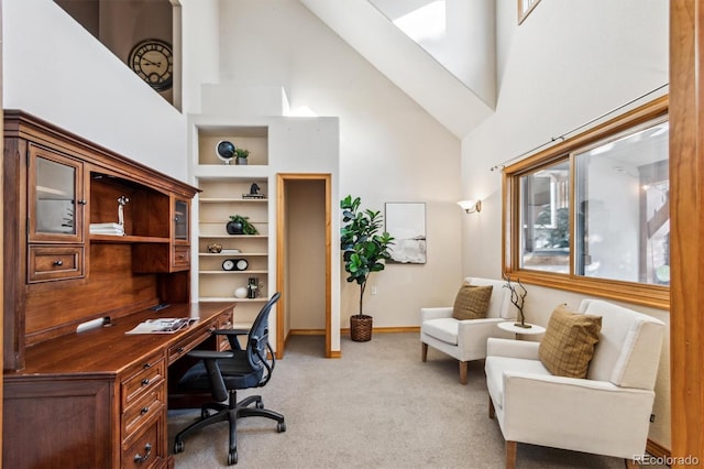 home office with high vaulted ceiling and light carpet