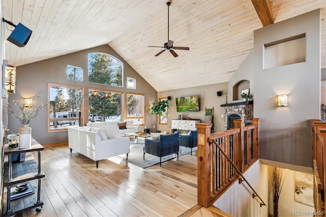 living room with wooden ceiling, a fireplace, high vaulted ceiling, and light wood-type flooring